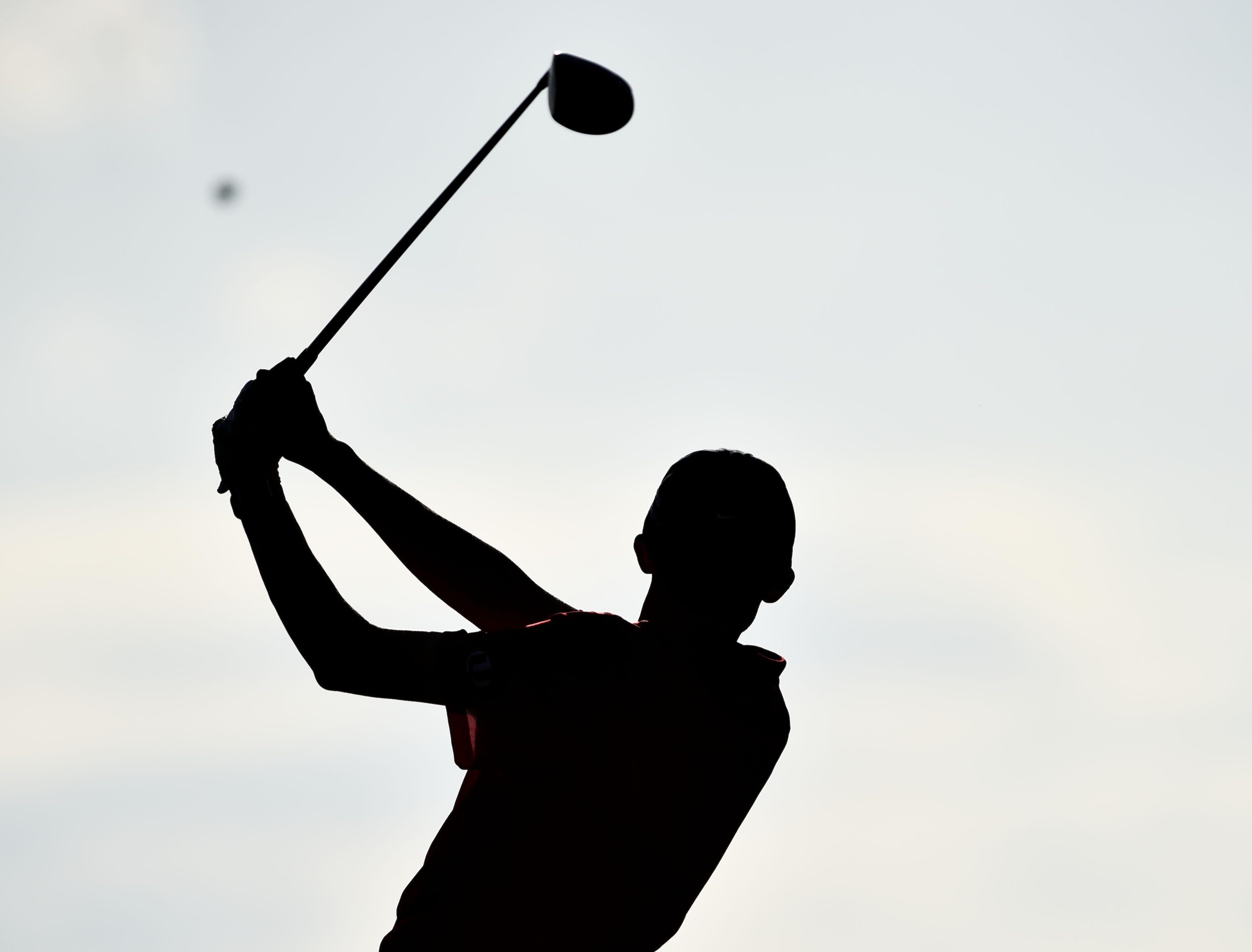 golfer tees off